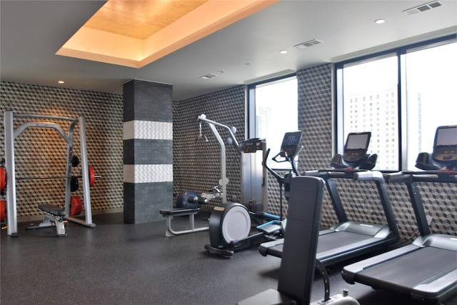 gym with a wall of windows