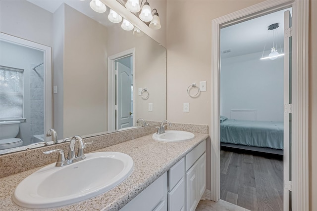 bathroom featuring wood-type flooring, vanity, and toilet