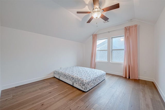 bedroom with lofted ceiling, hardwood / wood-style flooring, and ceiling fan