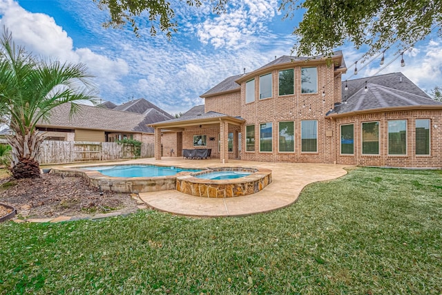 view of swimming pool with a yard, a patio area, and an in ground hot tub