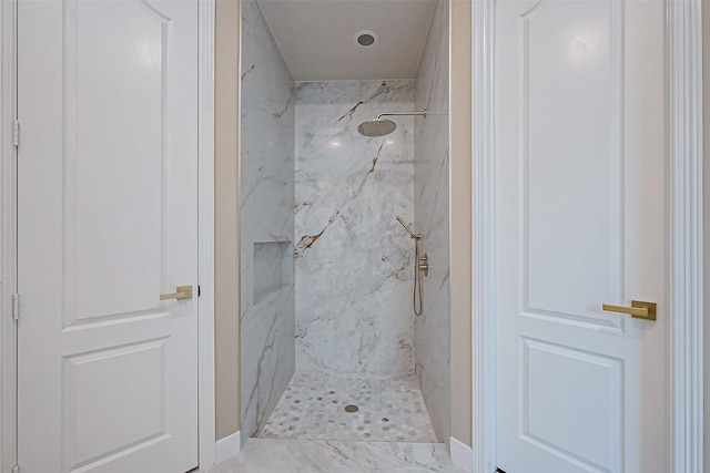 bathroom with a tile shower