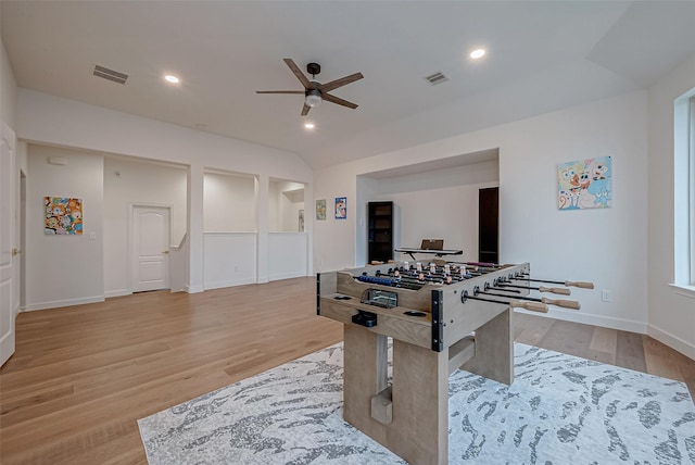 game room with ceiling fan, lofted ceiling, and light hardwood / wood-style floors