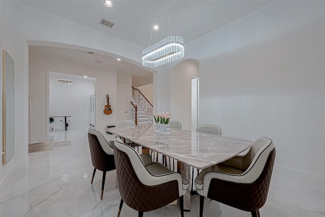 dining space with ornamental molding