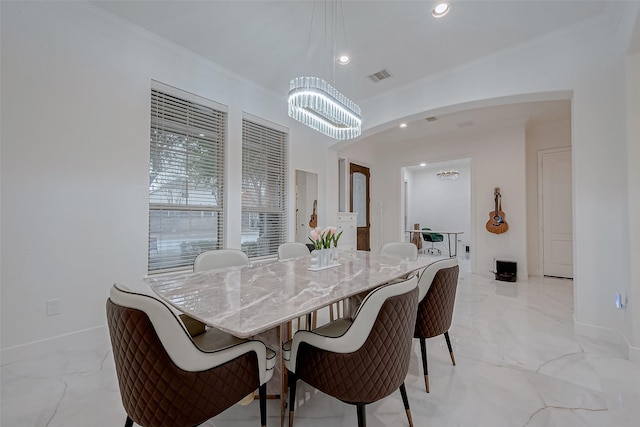 dining space with a notable chandelier and crown molding