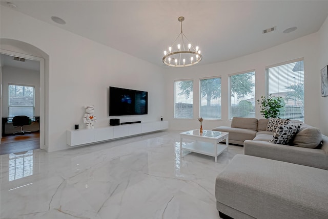 living room with a healthy amount of sunlight and an inviting chandelier