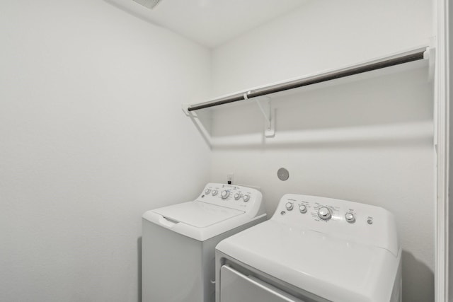 washroom with independent washer and dryer