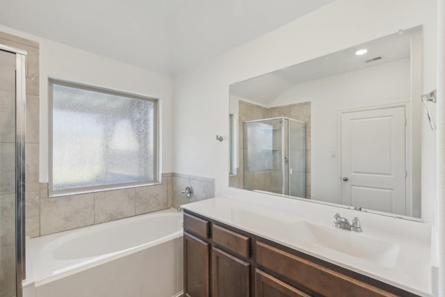 bathroom featuring vanity and independent shower and bath