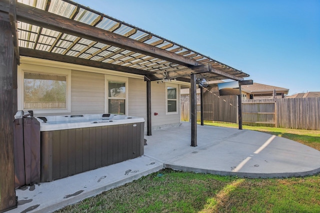 view of patio with a hot tub and a pergola