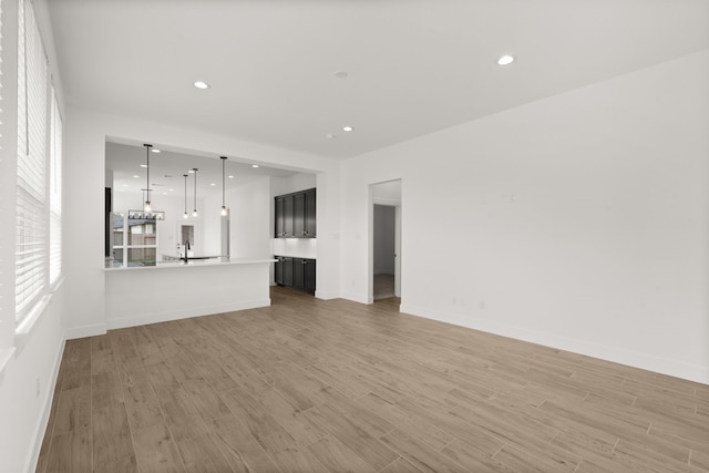 unfurnished living room with light hardwood / wood-style flooring