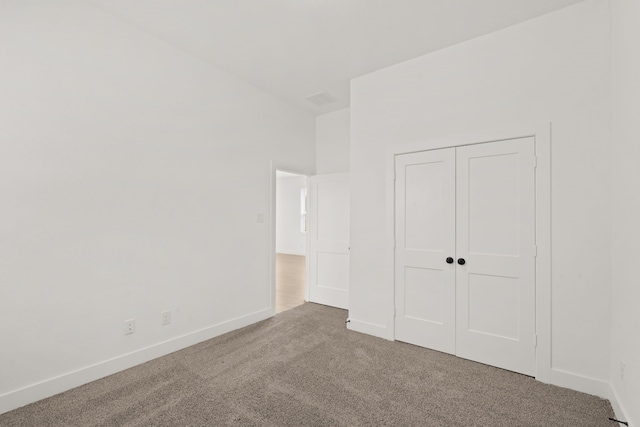 unfurnished bedroom with a closet and carpet