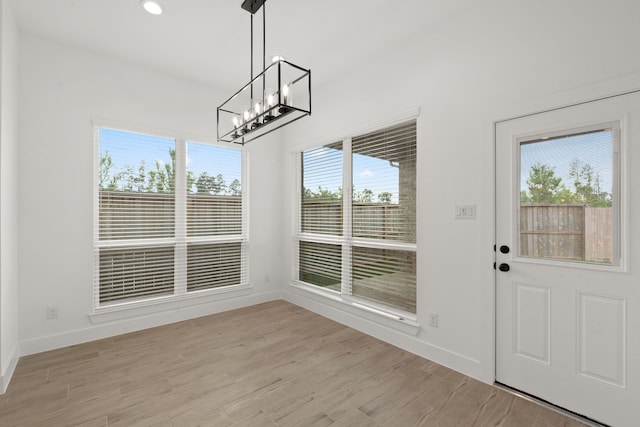 interior space with an inviting chandelier and light wood-type flooring