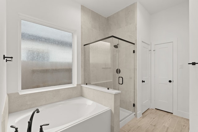 bathroom with separate shower and tub