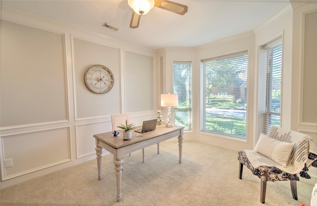 carpeted home office with crown molding and ceiling fan