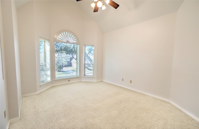 spare room featuring ceiling fan, light colored carpet, and high vaulted ceiling