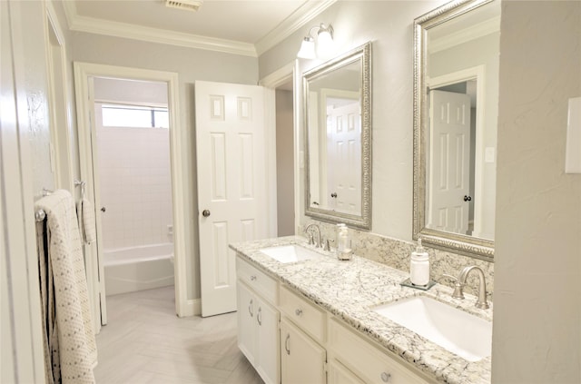 bathroom featuring crown molding, bathtub / shower combination, and vanity