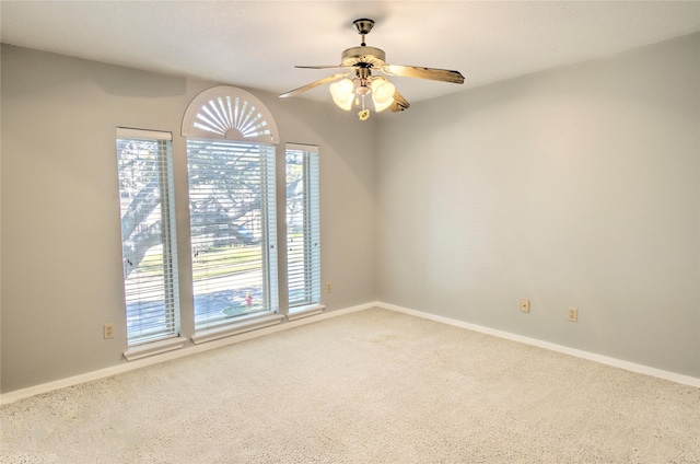 unfurnished room featuring ceiling fan and carpet flooring