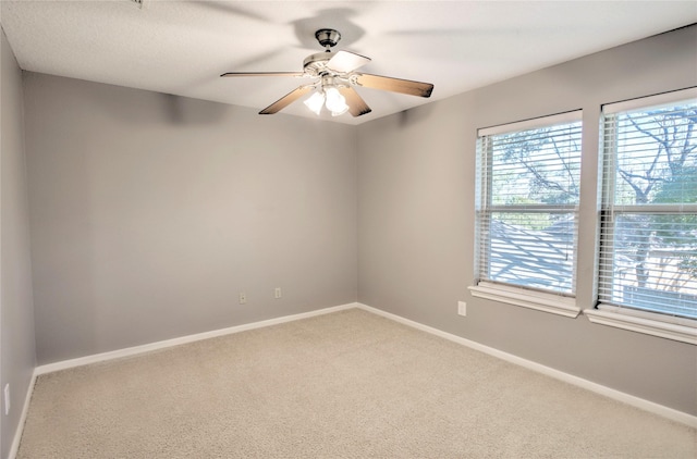 empty room with ceiling fan and carpet flooring