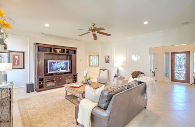 living room featuring crown molding and ceiling fan