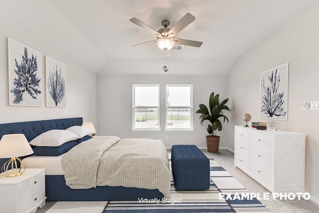 carpeted bedroom with a ceiling fan, lofted ceiling, and baseboards