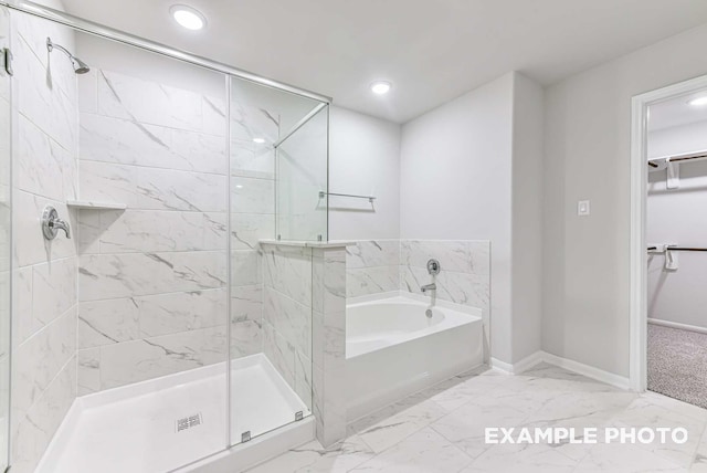 bathroom with a garden tub, baseboards, marble finish floor, a spacious closet, and a stall shower