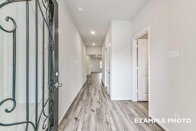 entryway with baseboards and wood finished floors