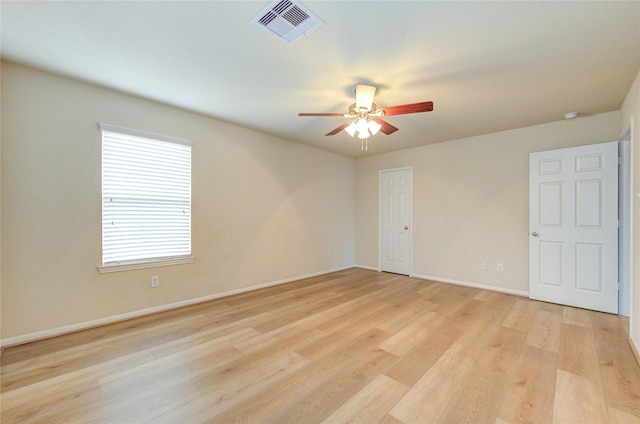 empty room featuring ceiling fan and light wood-type flooring