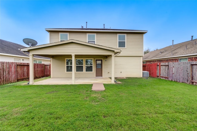 back of property featuring a patio, cooling unit, and a lawn