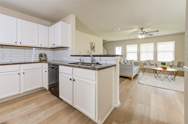 kitchen featuring sink, white cabinetry, dishwasher, kitchen peninsula, and light hardwood / wood-style floors