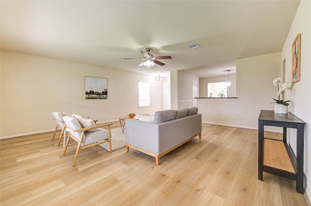 living room featuring ceiling fan and light hardwood / wood-style flooring