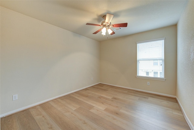 spare room featuring ceiling fan and light hardwood / wood-style flooring