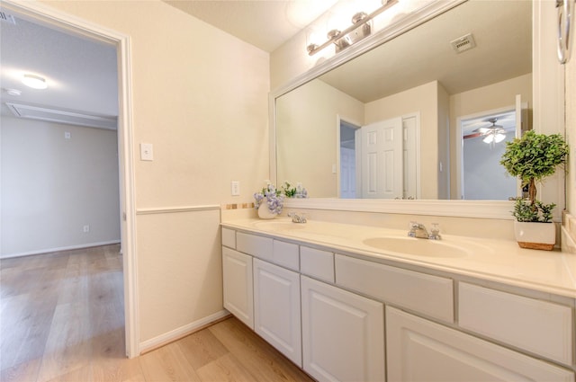 bathroom with vanity, hardwood / wood-style flooring, and ceiling fan