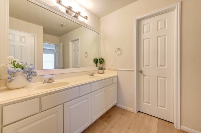 bathroom featuring vanity and hardwood / wood-style floors