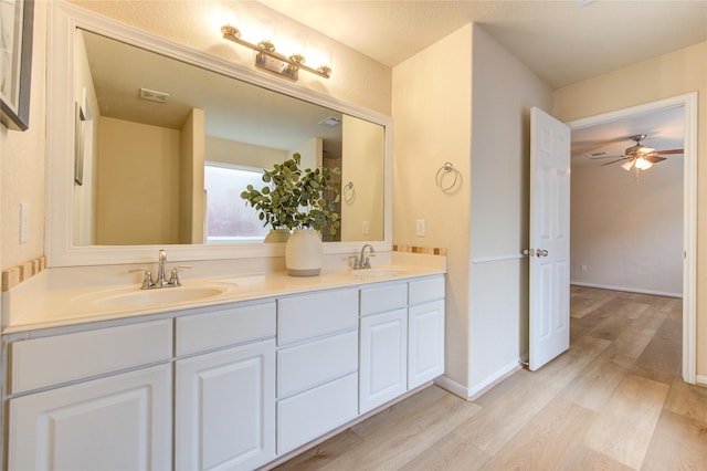 bathroom featuring vanity, hardwood / wood-style floors, and ceiling fan