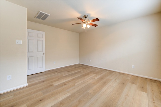 spare room with ceiling fan and light wood-type flooring