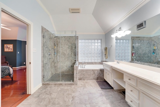 bathroom featuring ornamental molding, vaulted ceiling, and vanity