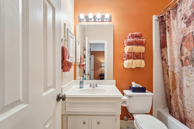 full bathroom featuring vanity, shower / bath combo with shower curtain, and toilet