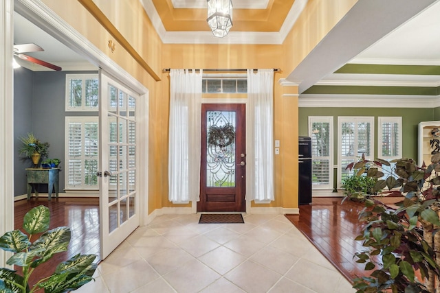 tiled entryway featuring french doors, crown molding, and a wealth of natural light