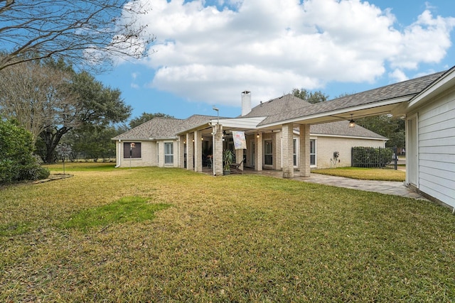 back of house featuring a yard