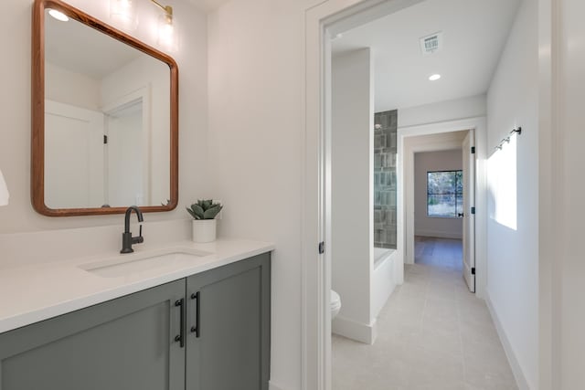 bathroom with vanity, tile patterned flooring, and toilet