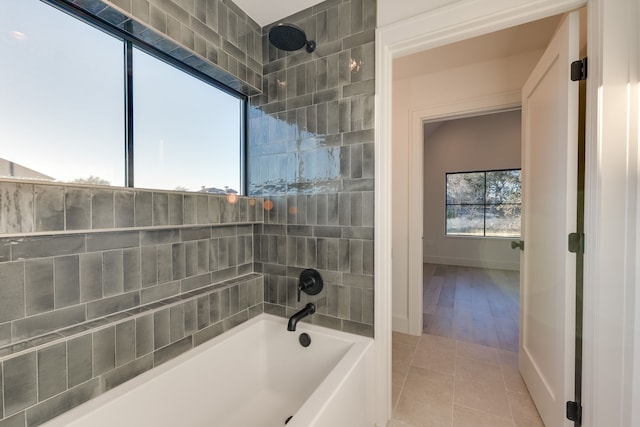 bathroom with tile patterned flooring and tiled shower / bath