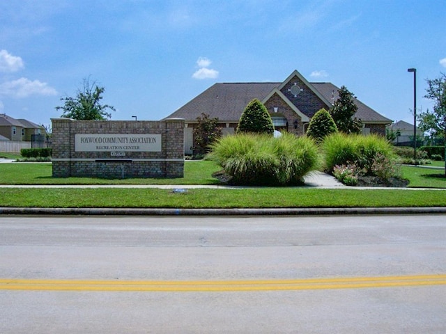 community / neighborhood sign with a lawn