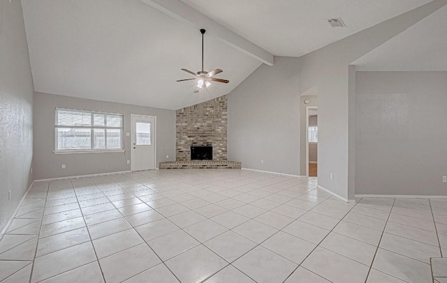 unfurnished living room with lofted ceiling with beams, light tile patterned flooring, a fireplace, and ceiling fan