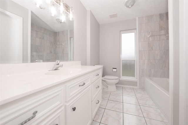 full bathroom featuring tile patterned flooring, vanity, tiled shower / bath combo, toilet, and a textured ceiling