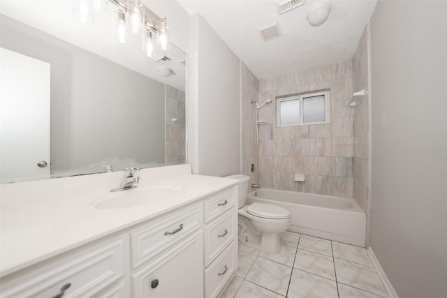 full bathroom with tiled shower / bath, vanity, a textured ceiling, and toilet