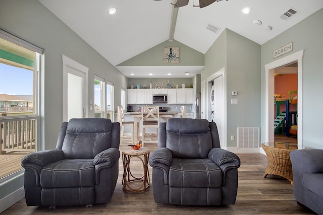 living room with dark wood finished floors, beam ceiling, baseboards, and visible vents
