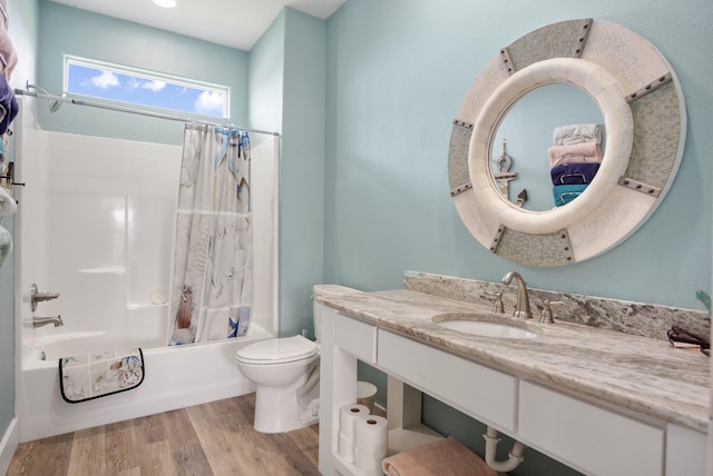 full bathroom featuring vanity, toilet, wood finished floors, and shower / bath combo