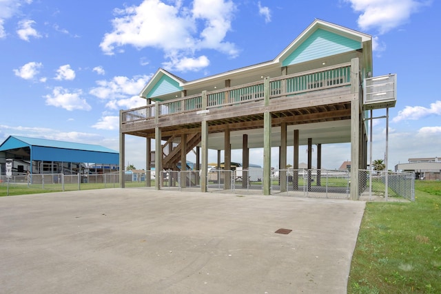 view of front of property with a carport, driveway, and fence