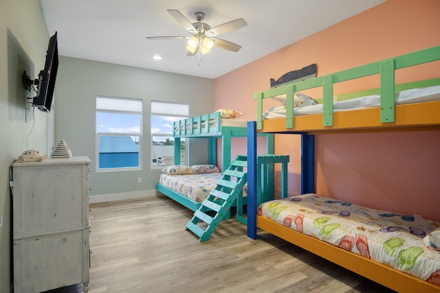bedroom featuring a ceiling fan, wood finished floors, and baseboards