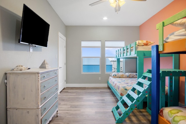 bedroom with wood finished floors, baseboards, and ceiling fan