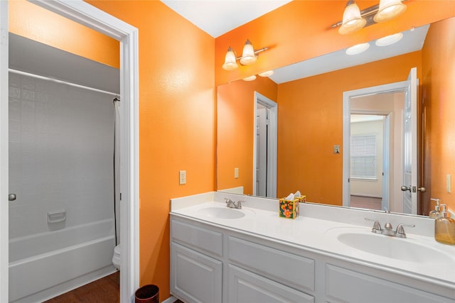 full bathroom with vanity, wood-type flooring, shower / bath combination with curtain, and toilet